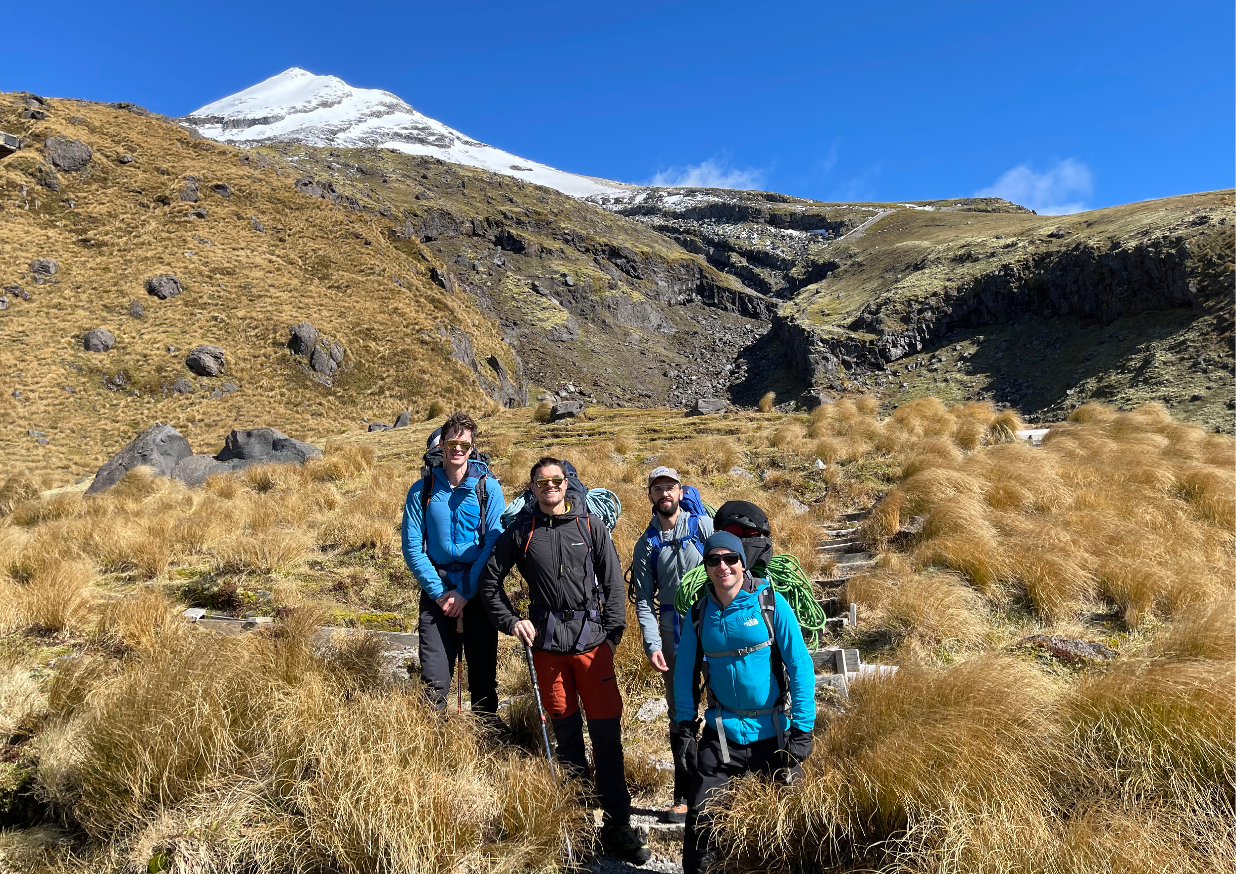 Team photo at the base — Sam Brown, Dan Waterston, Eric Buscaro and James Johnson, Taranaki behind