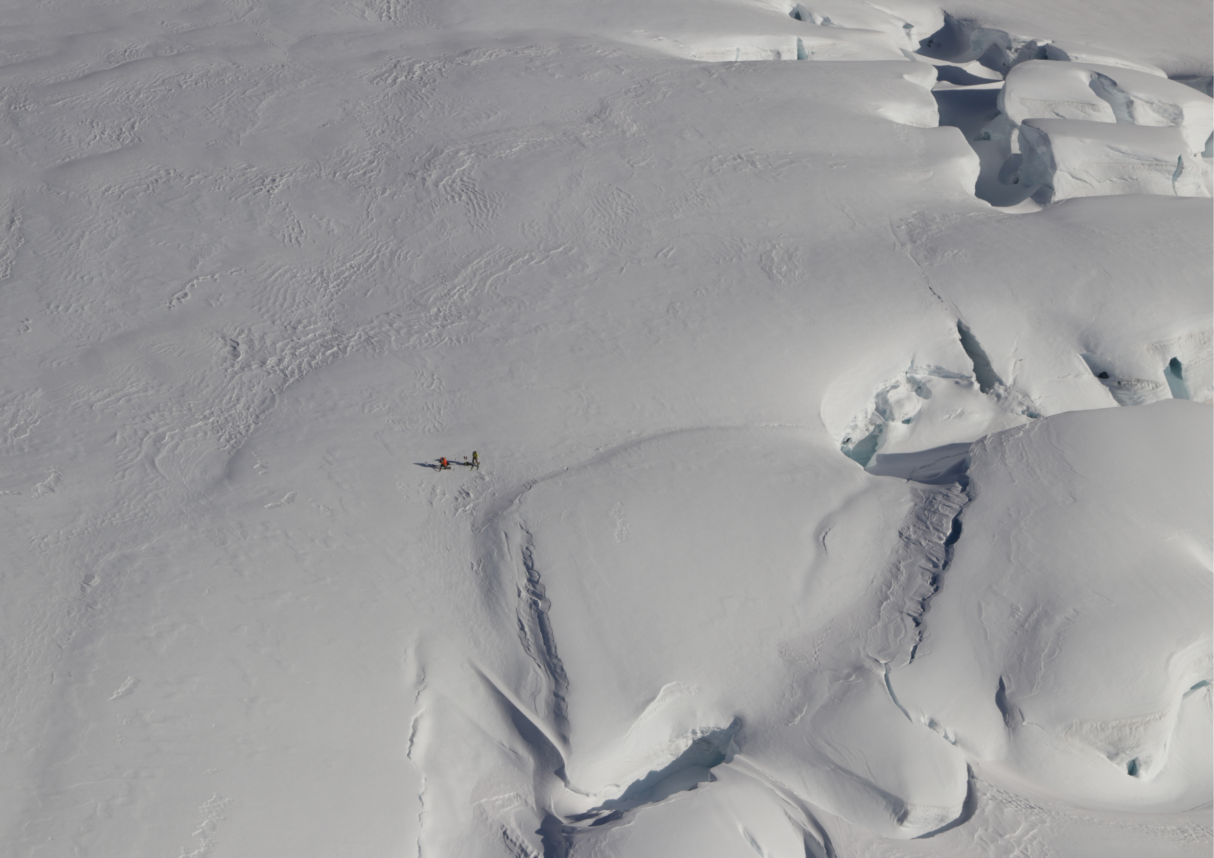 Aerial view of a ski plane on the vast expanse of the Tasman Glacier with seracs alongside